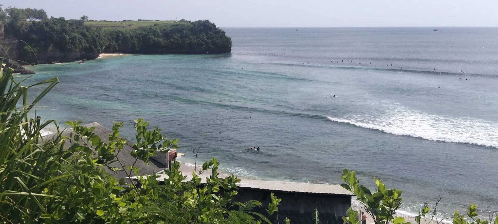 Surfers in the bay at Balangan, just along the coast from Bingin